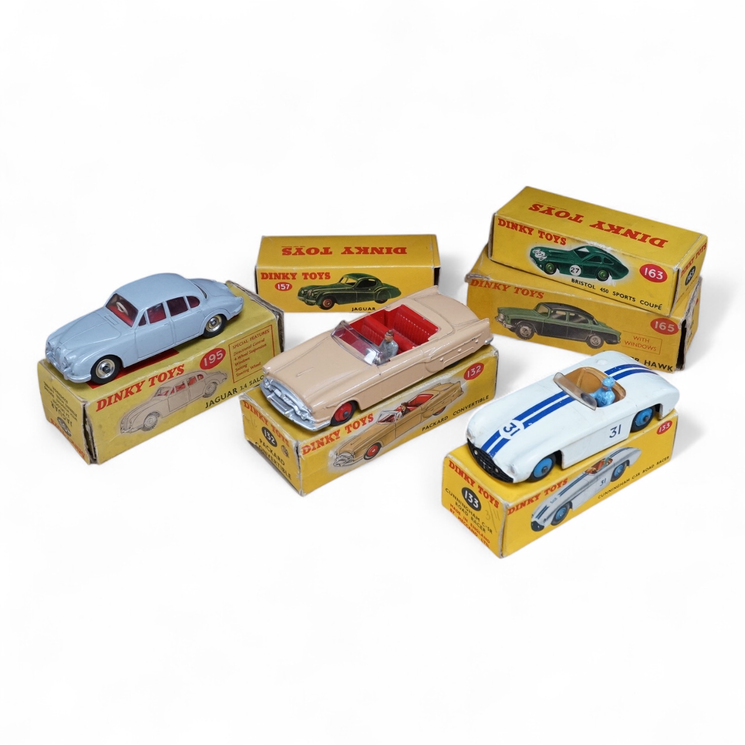 Six boxed Dinky Toys cars; Cunningham C-5R (133), Jaguar 3.4 saloon (195) in grey, Packard convertible (132) in fawn, Jaguar XK120 (157) in dark red (in a reproduction box), Humber Hawk (165) in two-tone green and black,